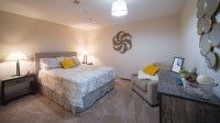 A cozy, modern bedroom with stylish decor and comfortable furnishings.