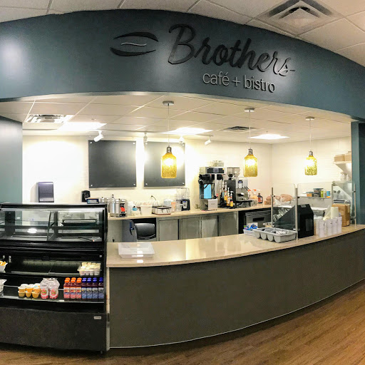 A cozy caf interior featuring a service counter with various beverages and snacks.