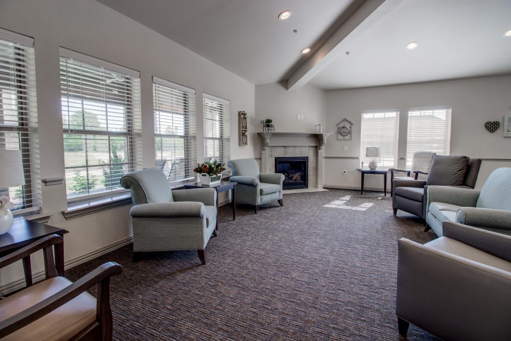 A cozy living room with comfortable seating, a fireplace, and ample natural light.