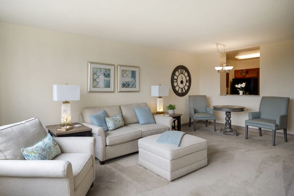 A modern living room with neutral tones and cozy furnishings.