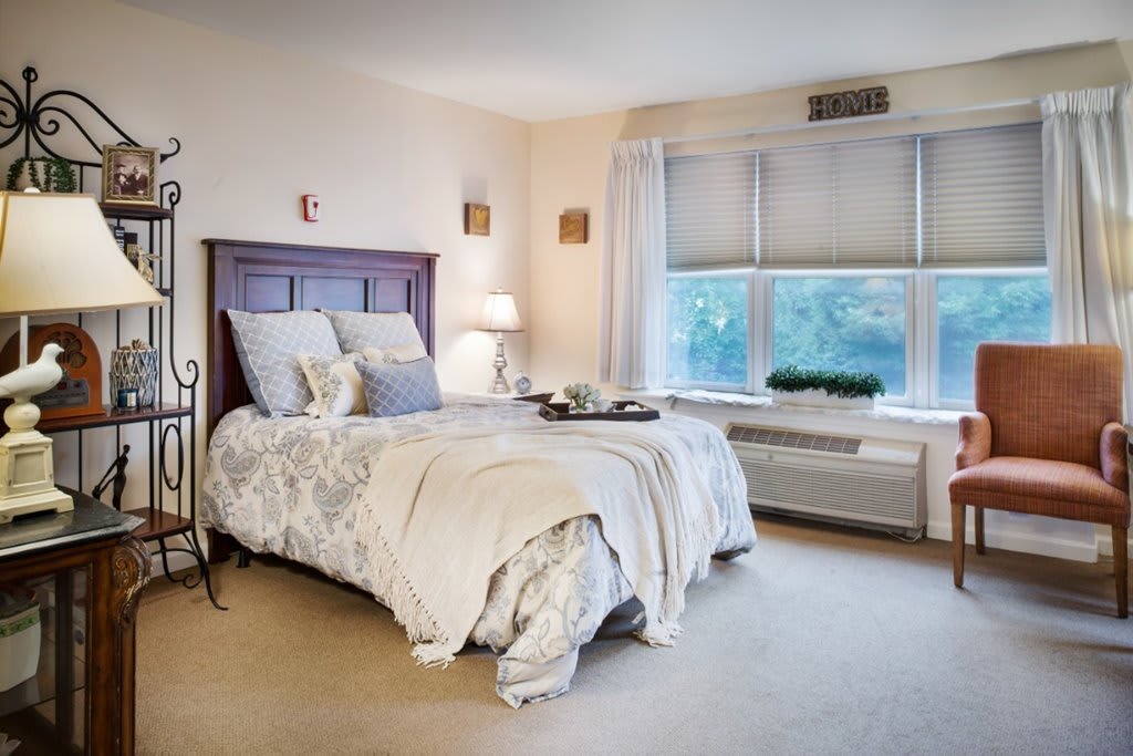 A cozy and well-decorated bedroom with a comfortable bed and ample natural light.
