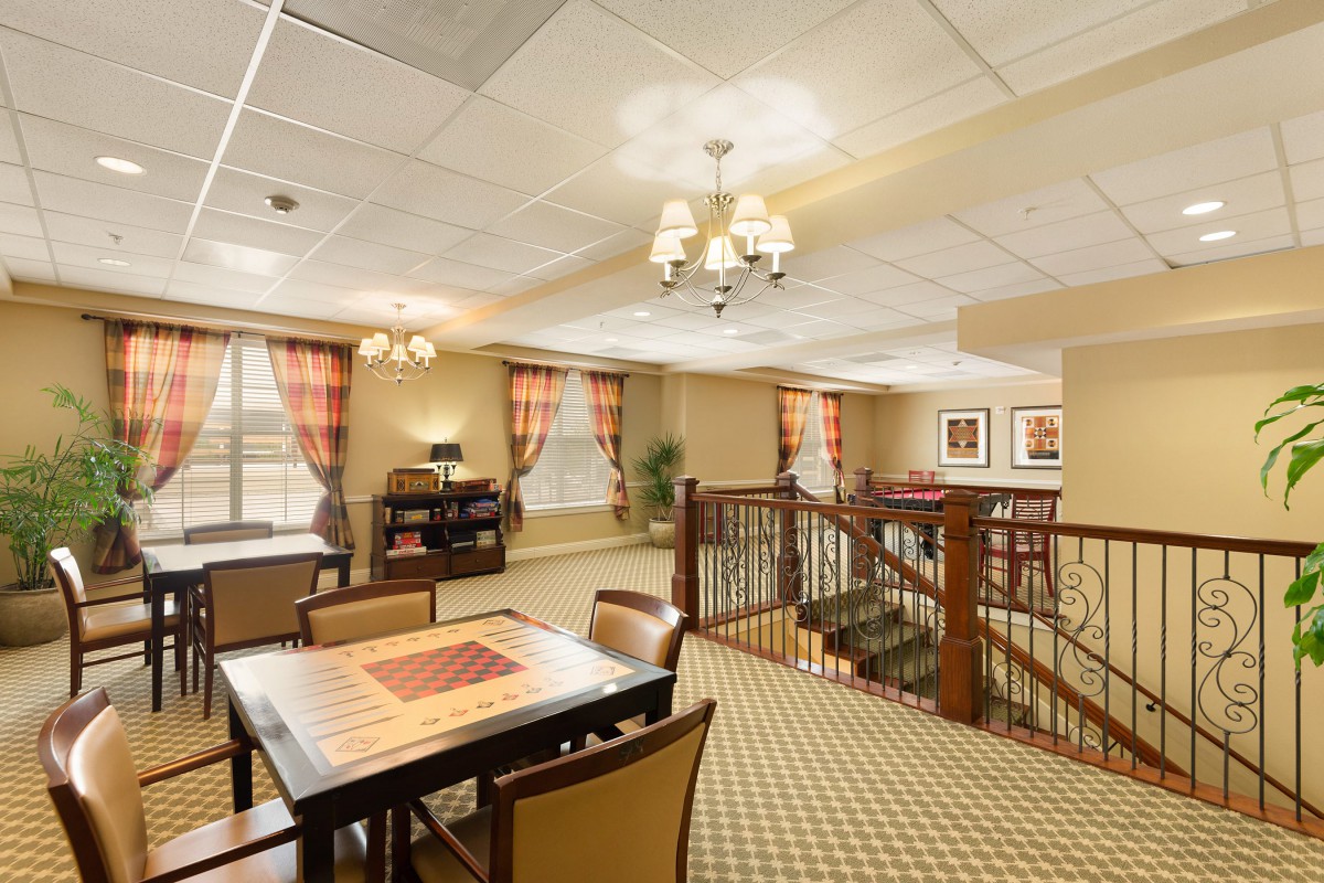 A cozy interior room with a seating area and a staircase.