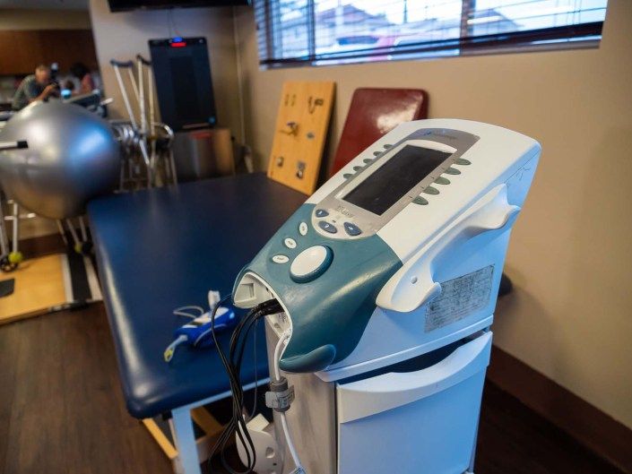 A therapy room with medical equipment used for rehabilitation.
