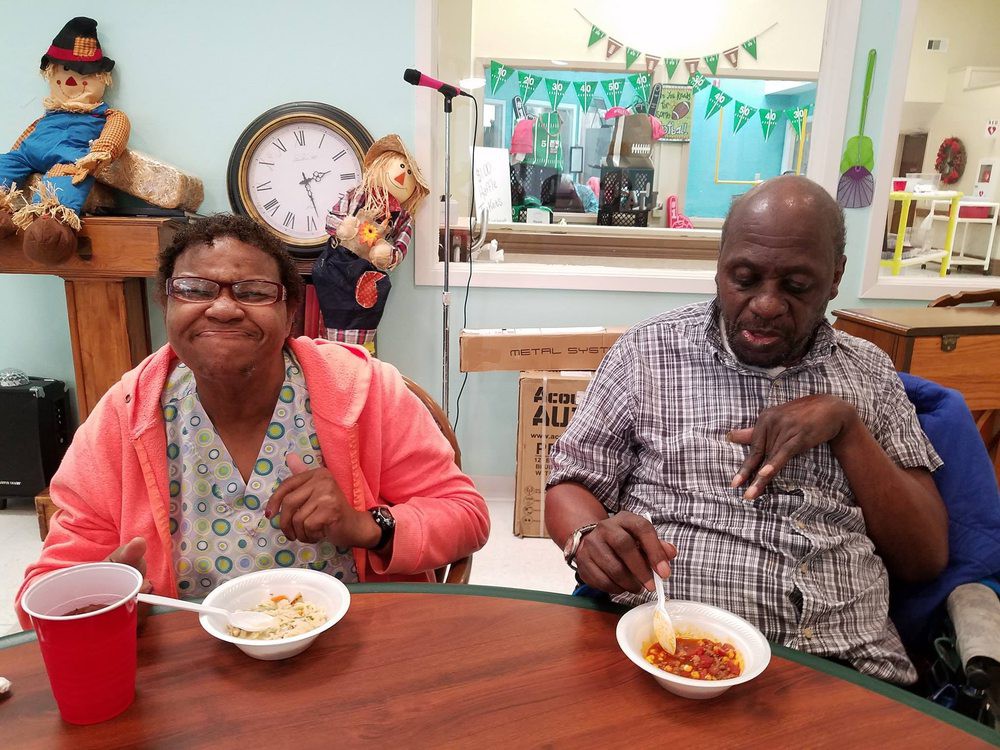 Two people enjoying a meal together at a table in a casual setting.