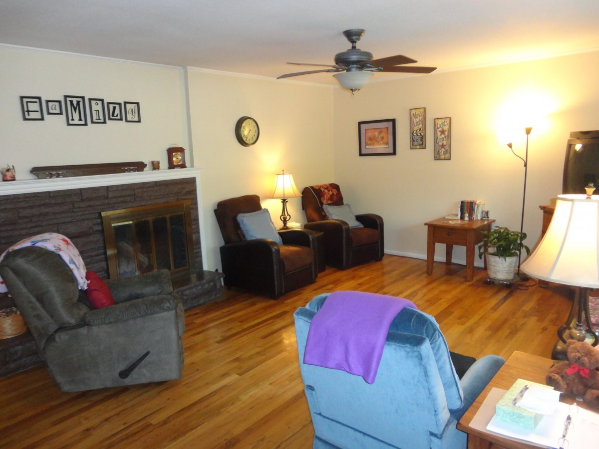 A cozy living room with comfortable seating and a fireplace.