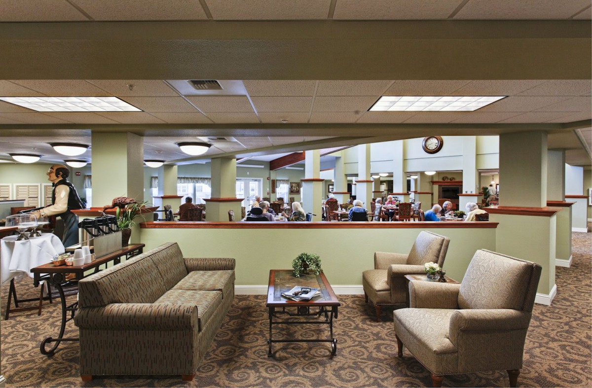A comfortable waiting area with sofas and chairs in an office setting.