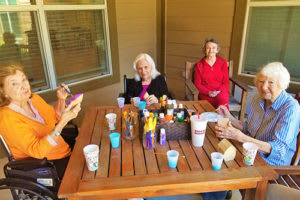 A group of people enjoying a meal together outside on a patio.