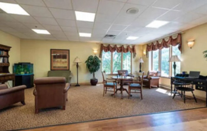 A cozy living room with comfortable seating and large windows.
