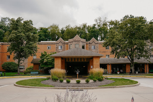 A beautifully designed building surrounded by lush greenery.