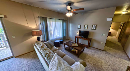 A cozy and inviting living room featuring comfortable seating and warm lighting.
