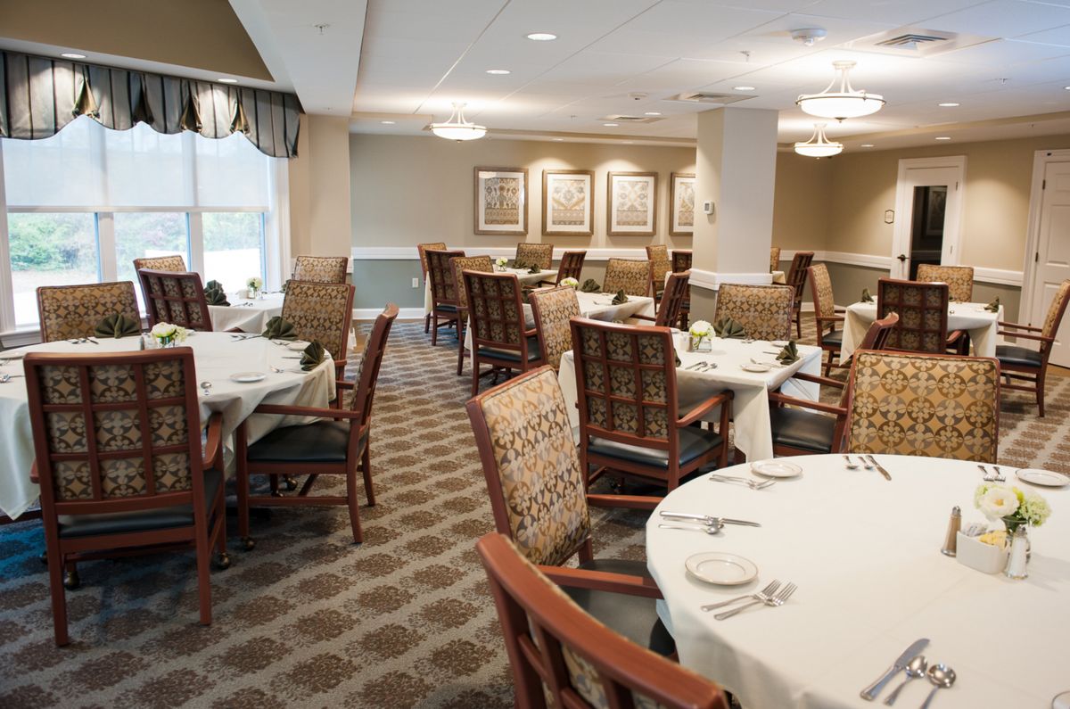 An elegant dining area with neatly arranged tables and chairs, ready for guests.
