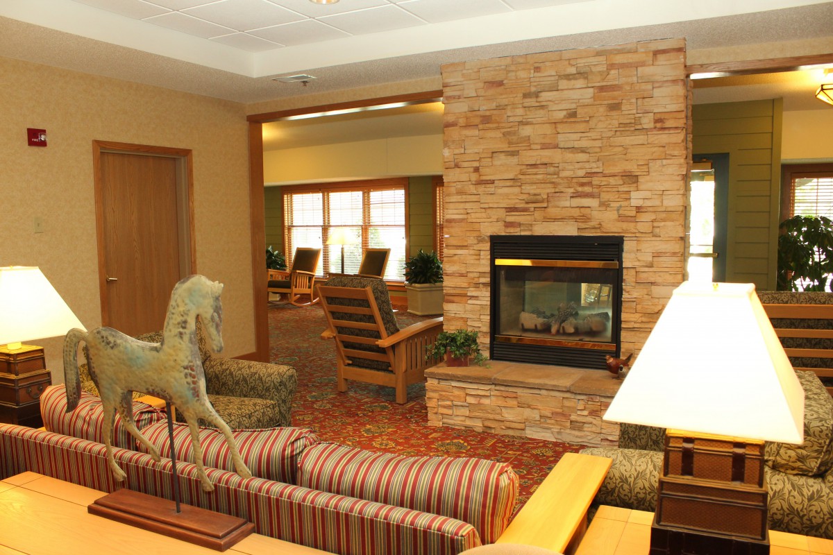 A cozy living room with a modern fireplace and comfortable seating.