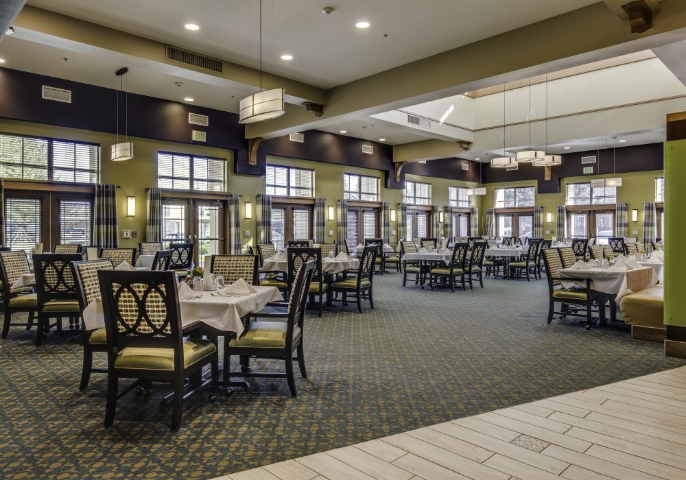An elegant and spacious dining area with neatly arranged tables and ambient lighting.