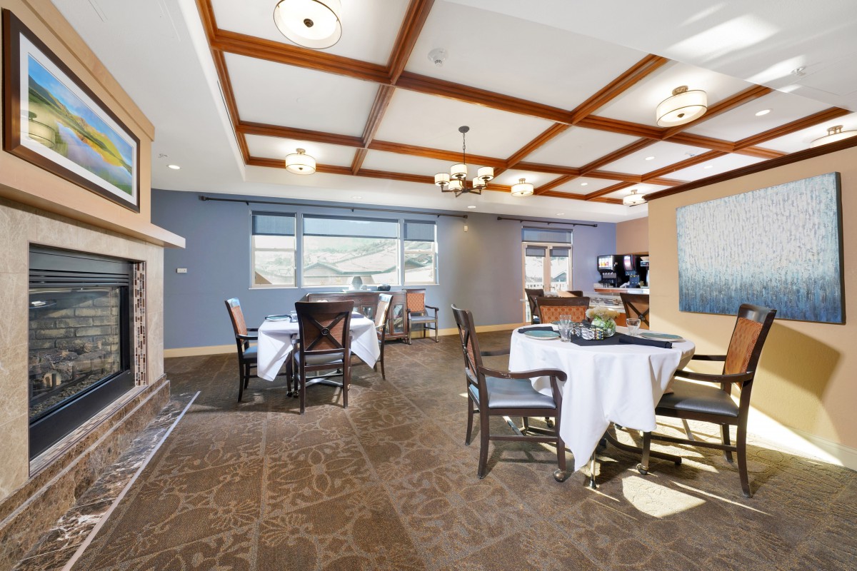 Spacious dining room with elegant furnishings and large windows.