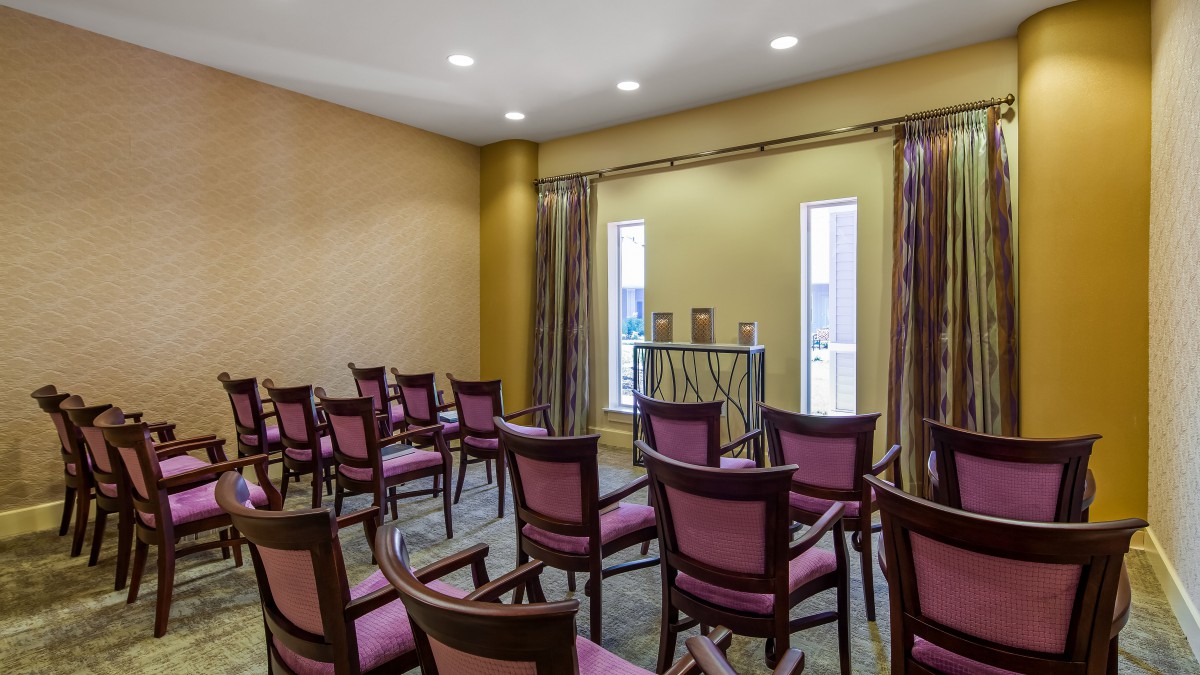 A small conference room with rows of chairs arranged for a meeting.