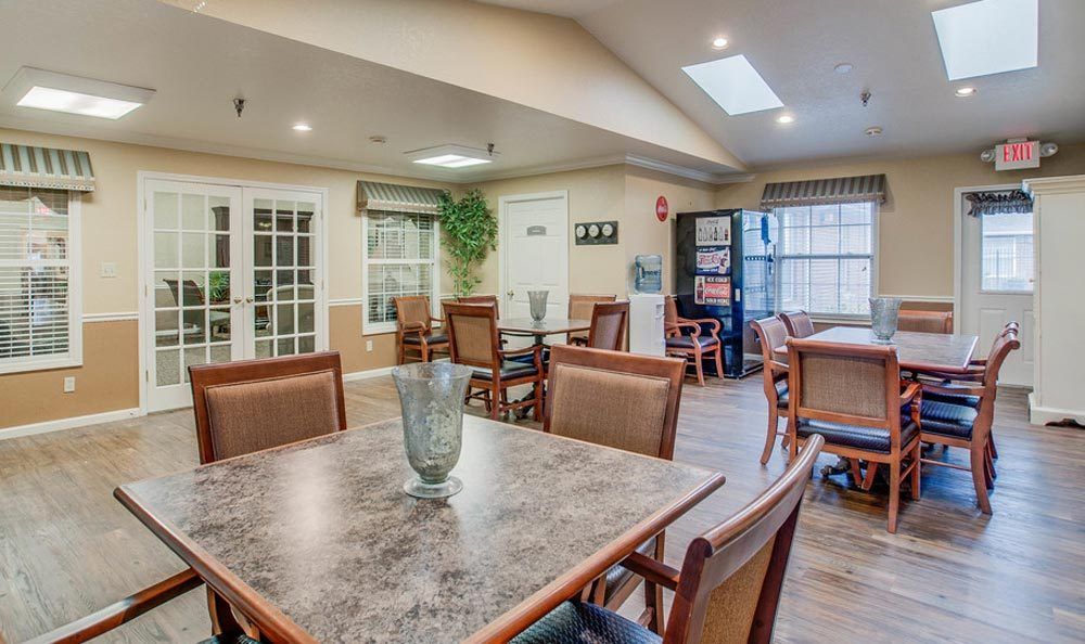 A well-lit dining area with tables and chairs arranged neatly.