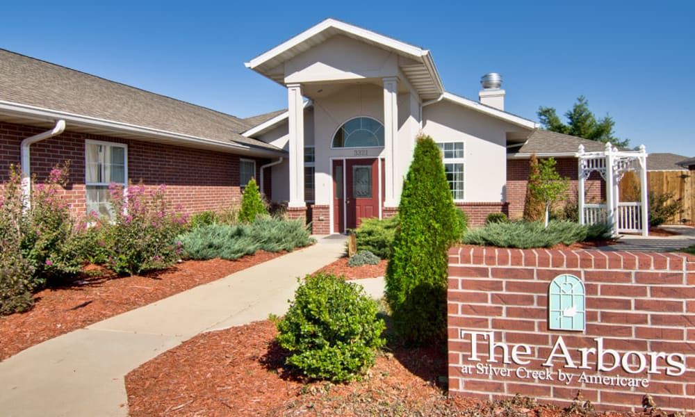 A modern building entrance with well-maintained landscaping.