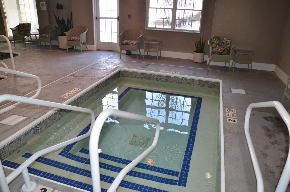 An indoor jacuzzi with tiled flooring, ready for relaxation.