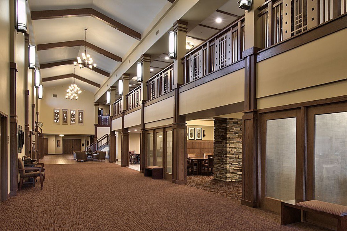 A spacious, modern hallway with elegant lighting and architectural details.
