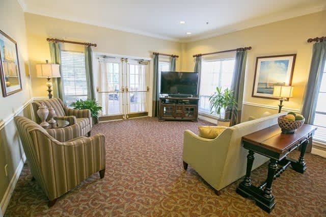 A cozy living room with comfortable seating and a large television.