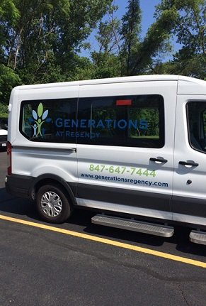 Side view of a branded van for Generations Urgent Care parked with trees in the background.