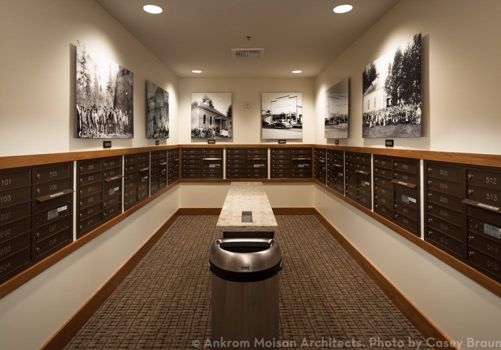 A museum hallway featuring historic photographs and a central bench for visitors.