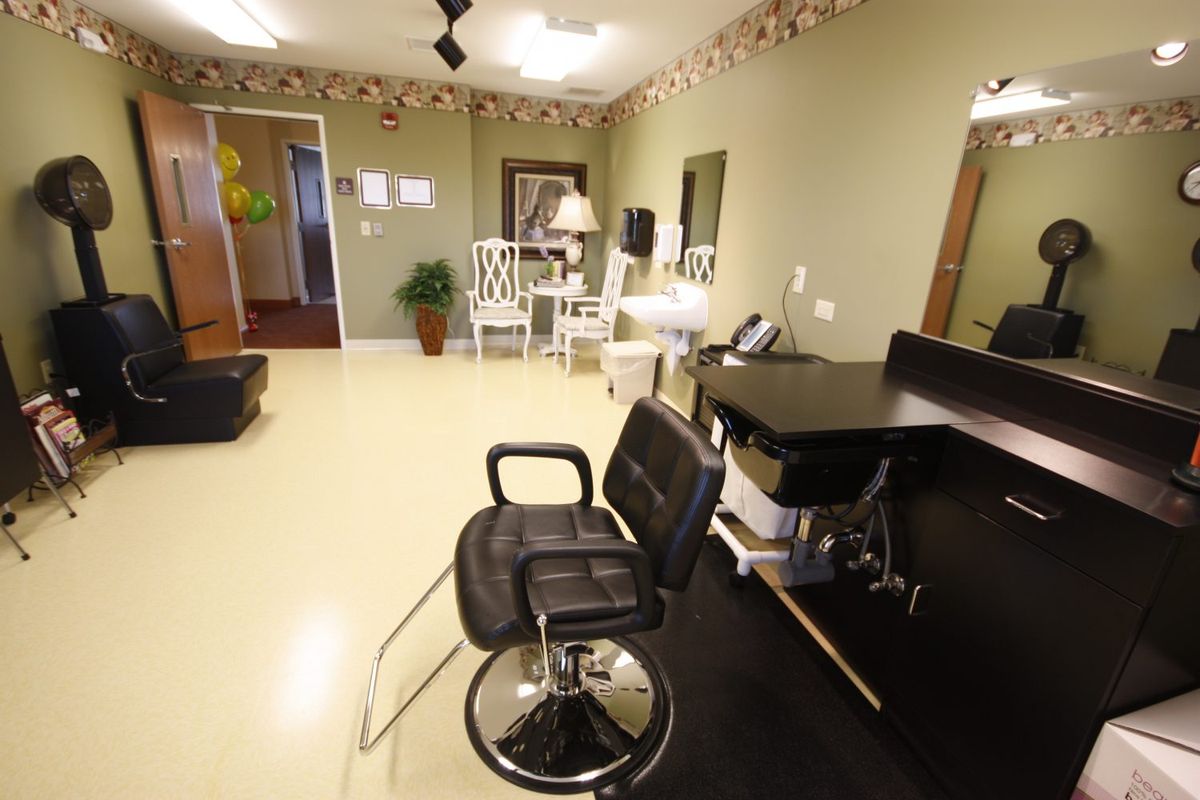 A well-lit hair salon interior with styling chairs and workstations.