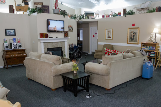 A cozy living room setup with beige sofas, a coffee table, and a television on the wall.