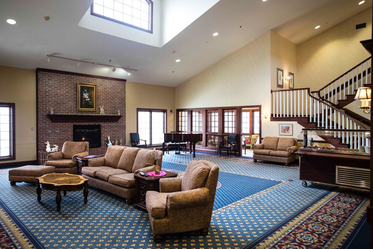 Spacious living room with comfortable seating and a fireplace.