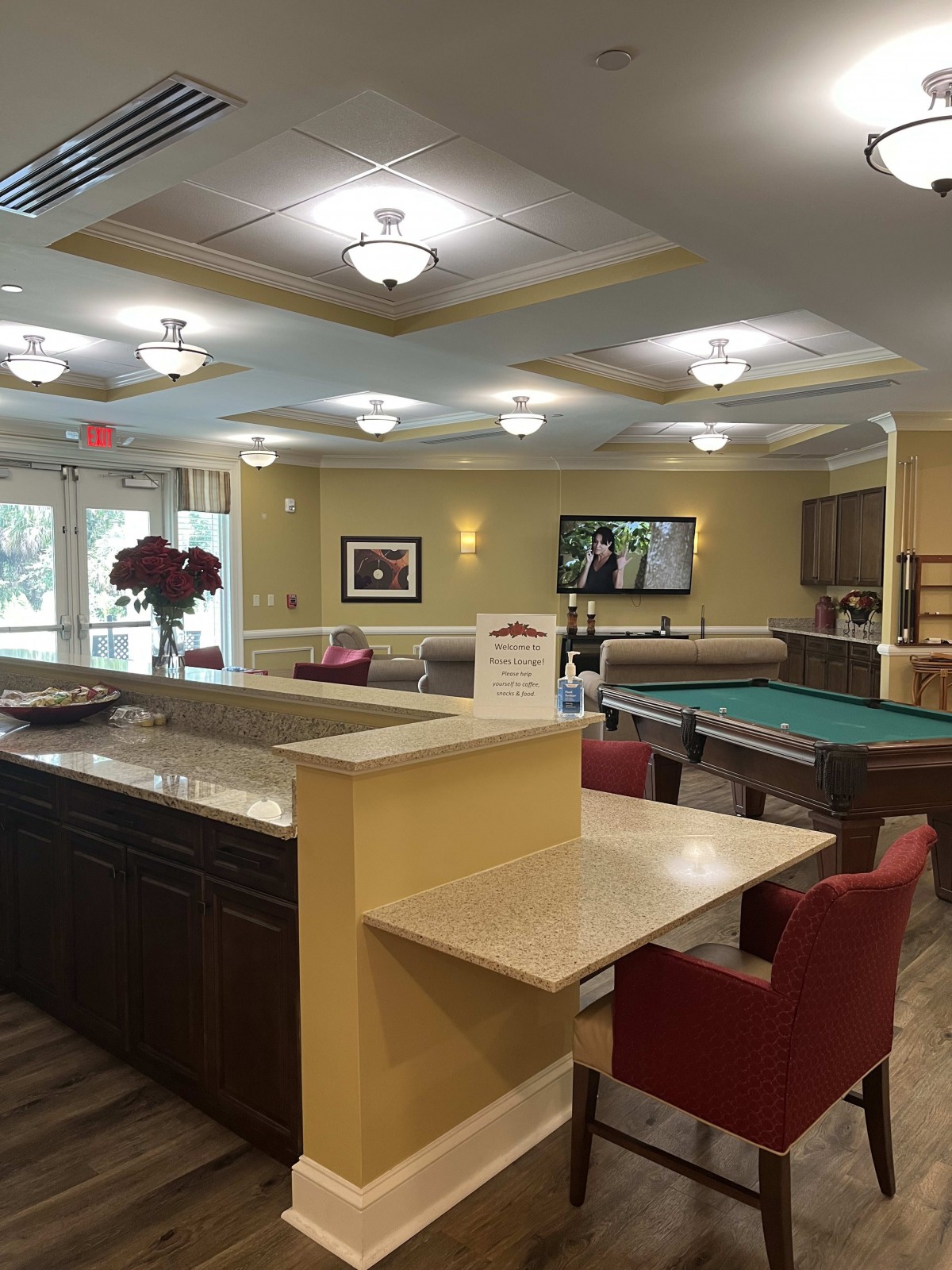 A modern lounge featuring a pool table and comfortable seating areas.