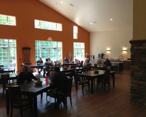 A cozy dining area with people enjoying their meals in a well-lit space.