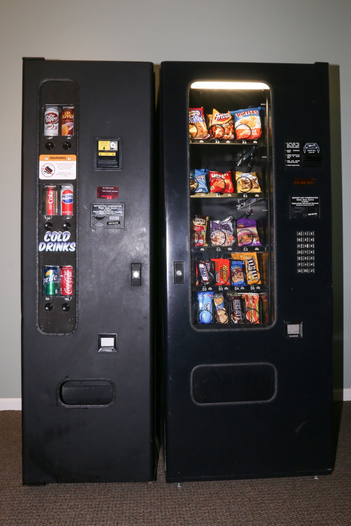 A pair of vending machines offering snacks and beverages.