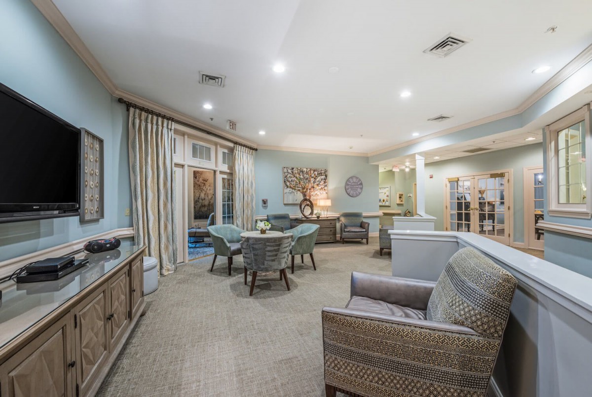 A spacious and elegantly decorated living room with comfortable seating and soft lighting.
