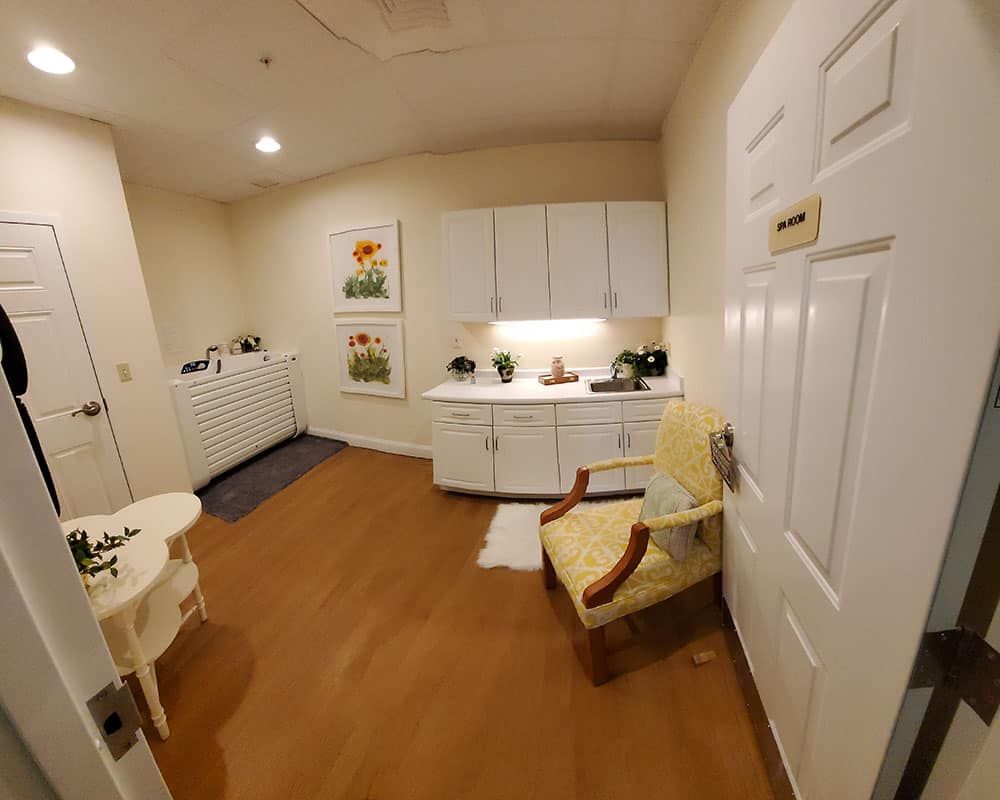 A cozy kitchenette with wooden flooring, cabinets, and various kitchen appliances.