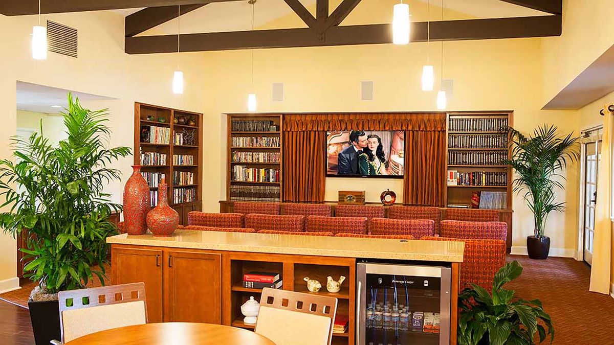 A cozy library interior with bookshelves and a television for entertainment.