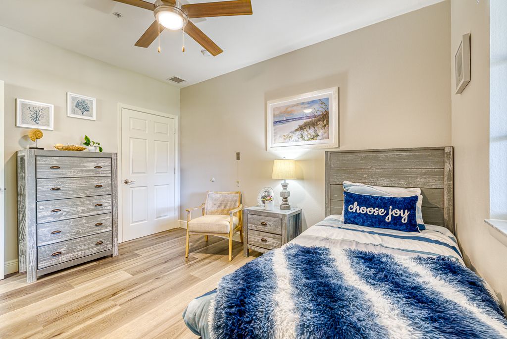 A cozy and modern bedroom featuring stylish decor with a comfortable bed, artwork, and furniture.