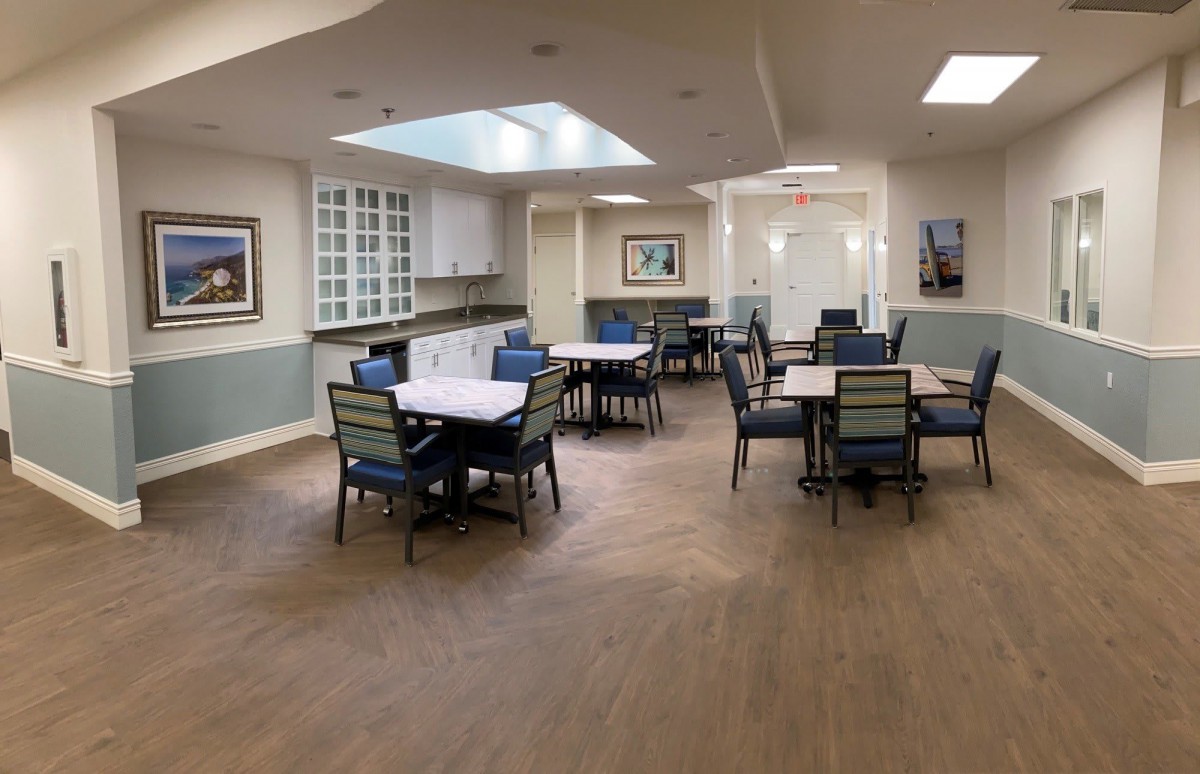 A spacious and well-lit dining area with neatly arranged tables and chairs.
