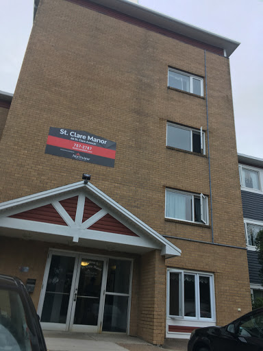 A multi-story apartment building featuring a prominent sign.