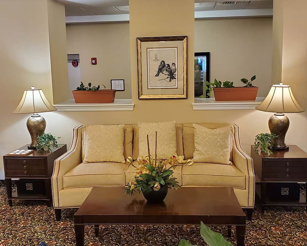 A cozy living room setup with a sofa, coffee table, and decorative elements.