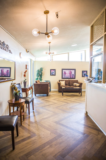 A stylish waiting room featuring comfortable seating and modern decor.