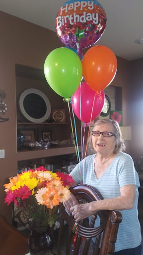 A joyful celebration with colorful balloons and vibrant flowers.