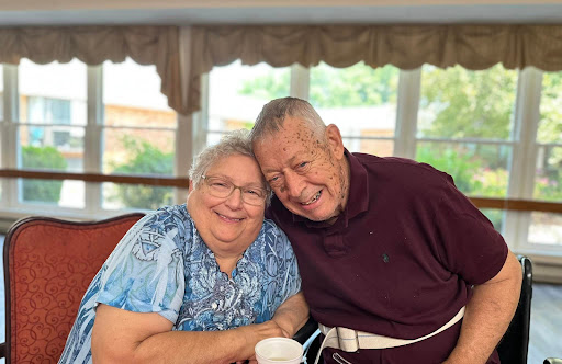 A joyful moment shared between two elderly friends, showcasing their bond and happiness.