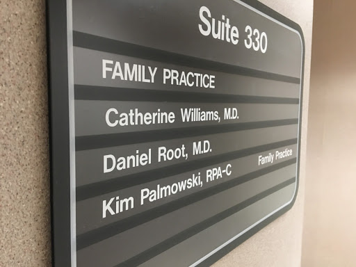 Sign indicating Suite 330 for a family practice, listing the associated doctors.