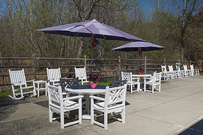Outdoor patio with tables, chairs, and umbrellas.