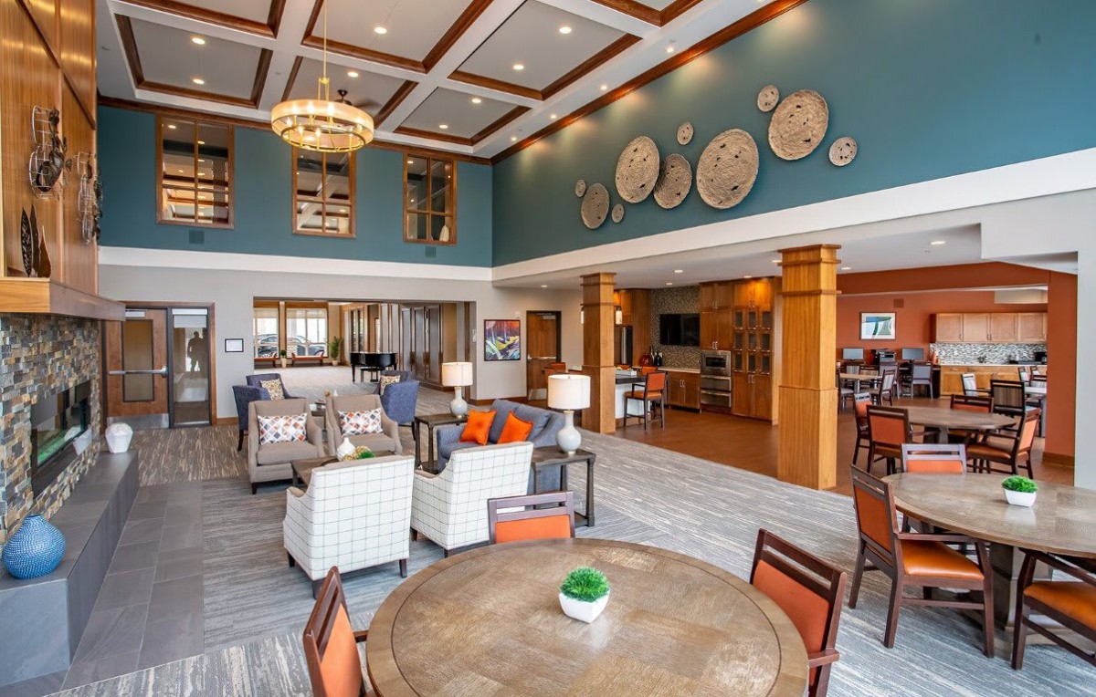 A modern and spacious lounge area with stylish furniture and decorative elements.