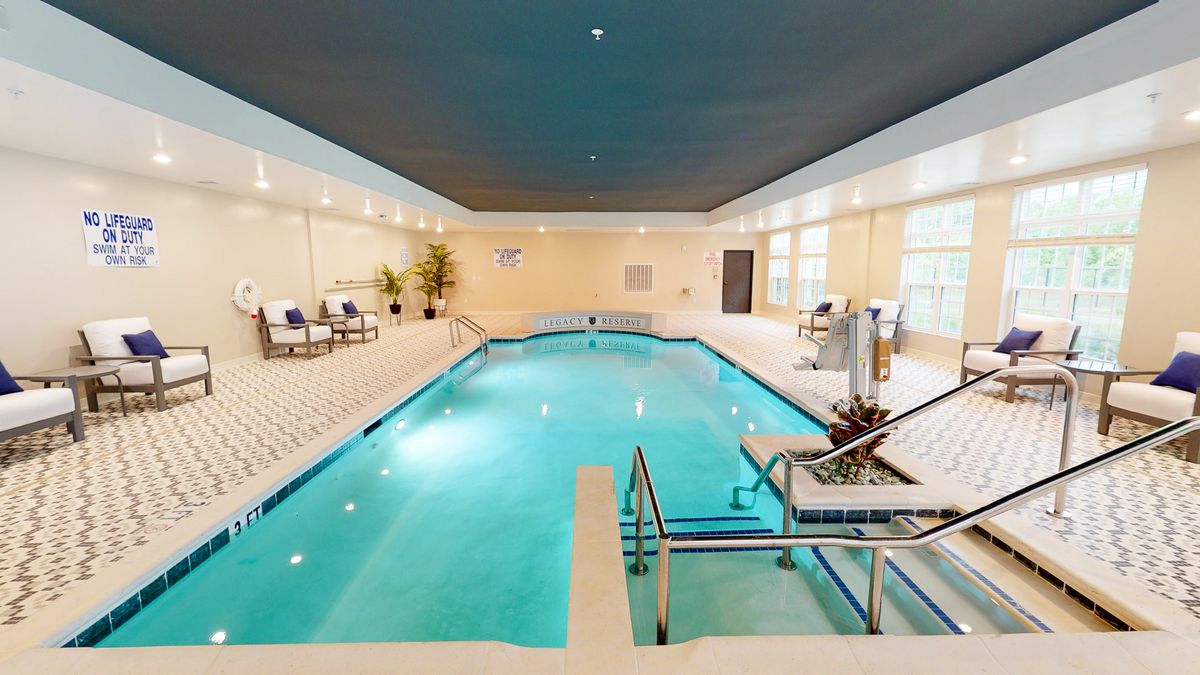 A tranquil indoor swimming pool area with seating and modern amenities.