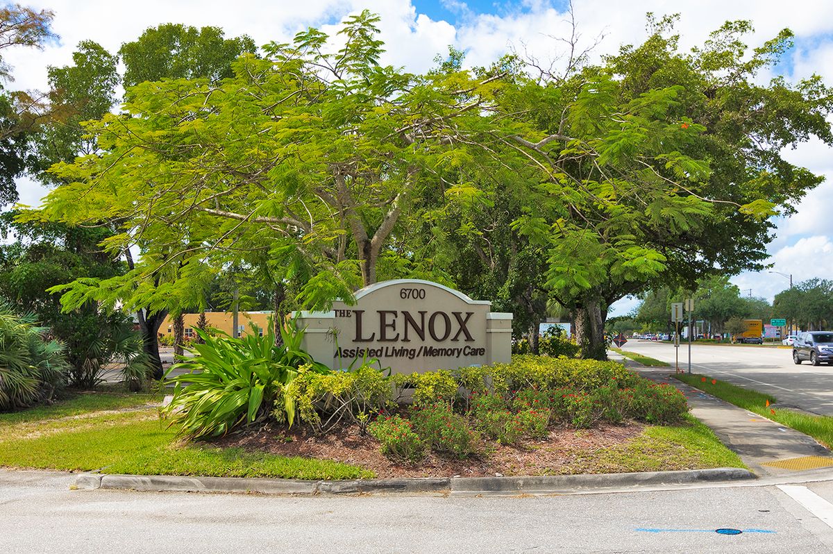 Entrance sign to Lenox community surrounded by lush greenery.