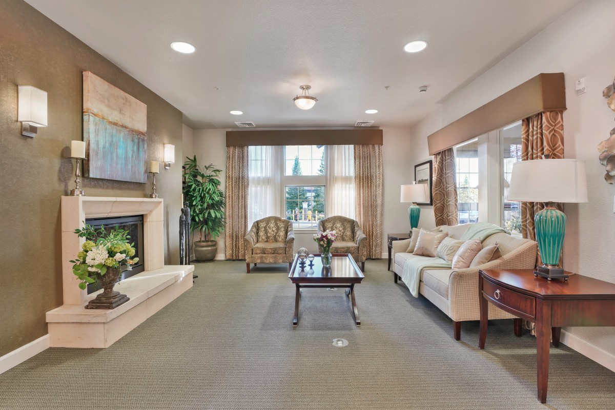 A cozy living room with elegant furnishings and a welcoming fireplace.