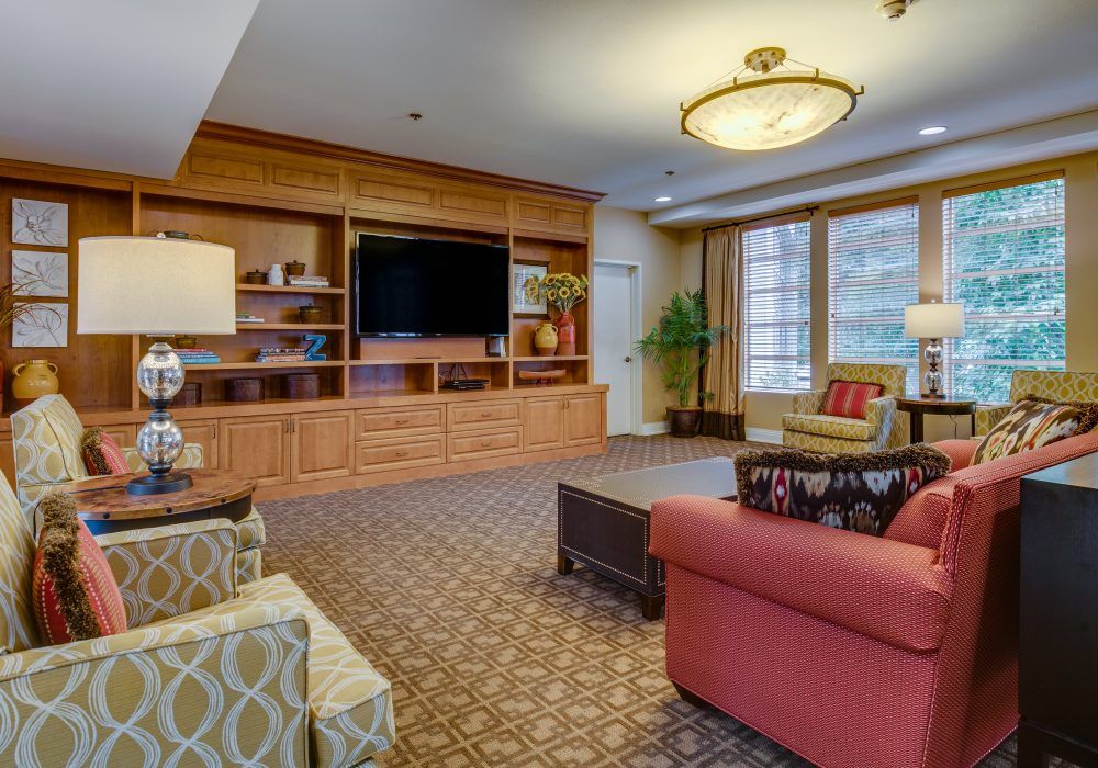 A cozy living room with comfortable furniture and a large television.
