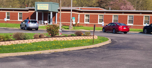 A community center with a well-maintained landscape and parking area.